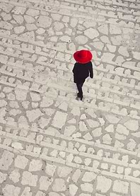 Woman in red hai in the stairs seeing from above