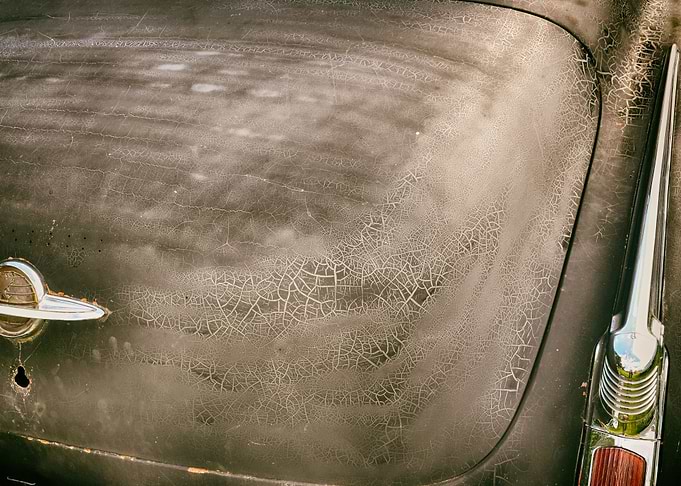Closeup of retro car with crackes in paint.