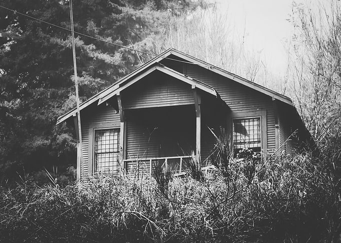 wooden house in the forest with rain in black and white ...