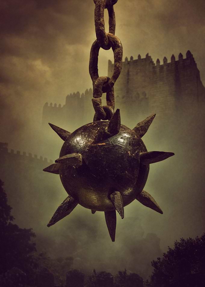 Hanging medieval spike ball with silhouette of a sinist ...