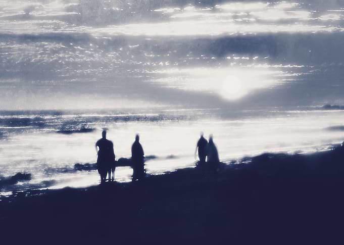 watching sunset at the beach in black and white
