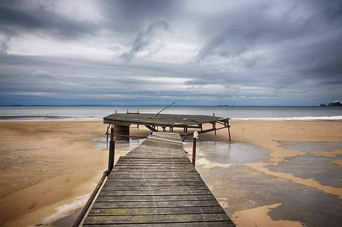 Old jetty on the beach a dramatic winter day.