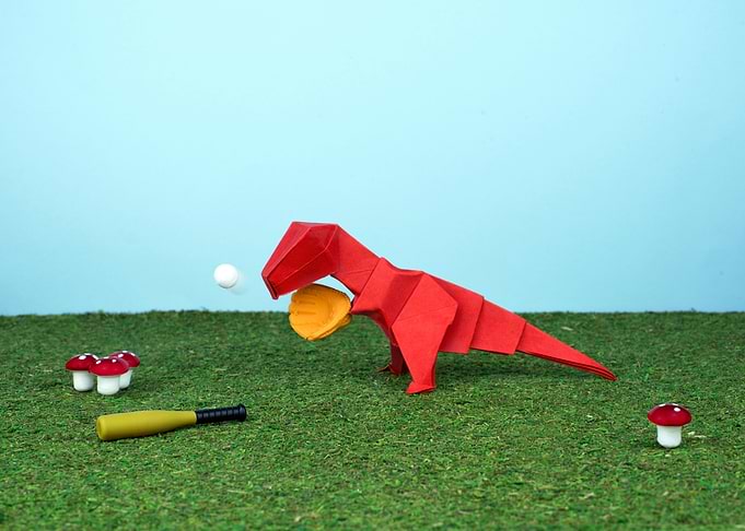 Yes T-Rex can! Red origami T-Rex playing baseball as p ...
