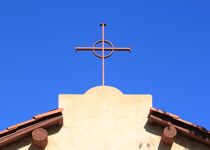 Church Cross Church top with a cross and blue sky in th ...