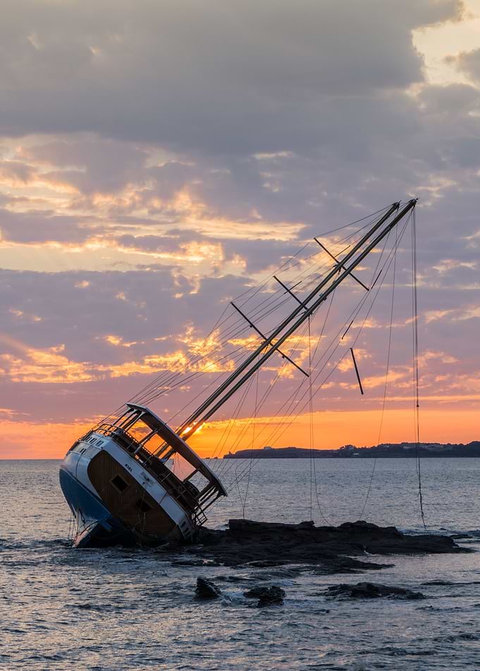 A beautiful sail boat wrecked on the coast