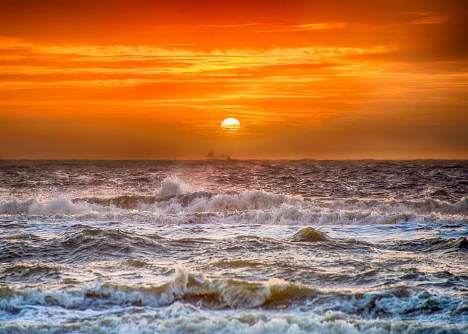 The crashing waves on the Dutch beach at sunset....