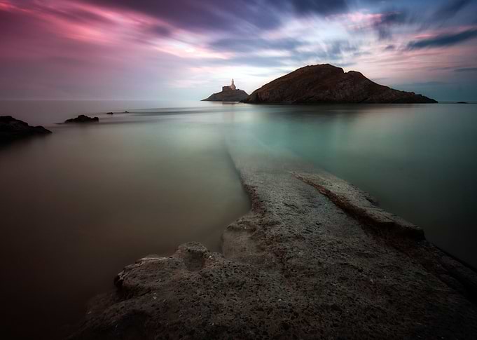 A calm full tide evening at Mumbles Lighthouse in Swans ...