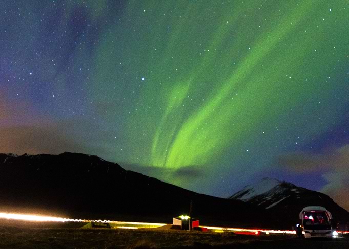 The Aurora Borealis over mountains in Iceland