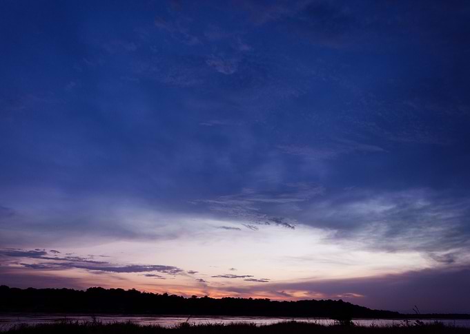 This is a stunning picture of the sun setting on the Ri ...