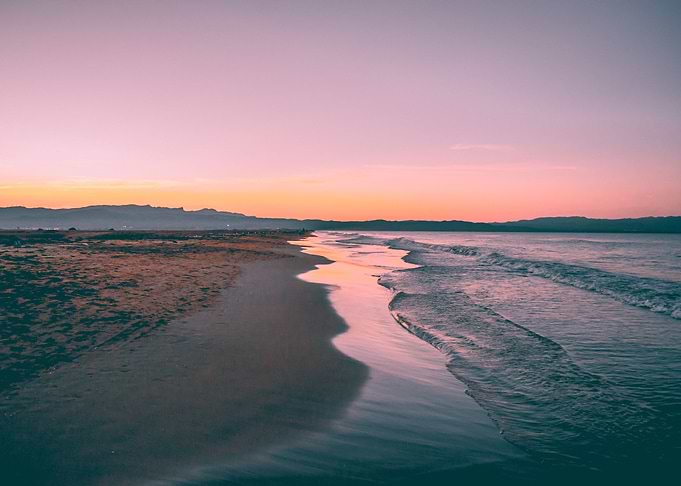 Sunset landscape between beach and sea.