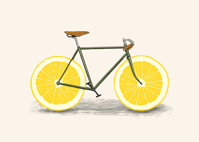 An old bike with slice of a lemon as the wheels
