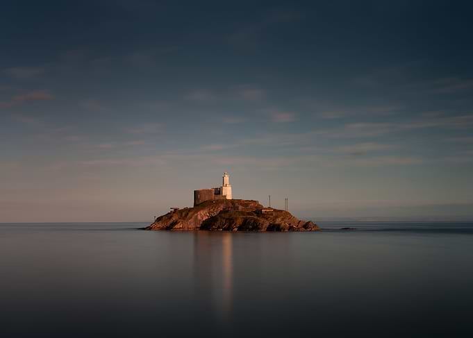 A calm full tide evening at Mumbles Lighthouse in Swans ...