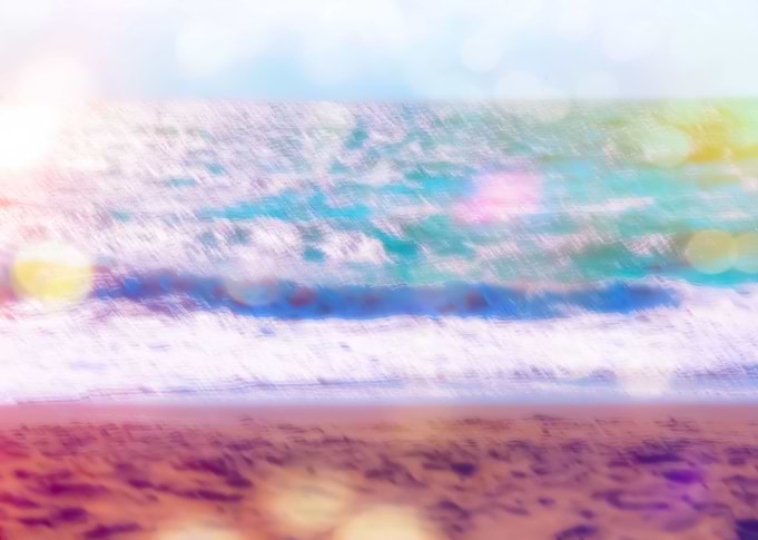 sandy beach with blue wave and summer light bokeh