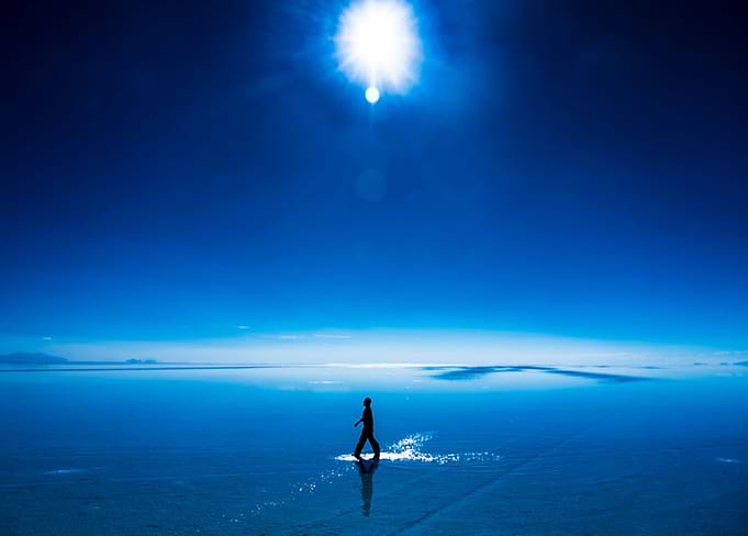 Man walking on water in Uyuni salt flats