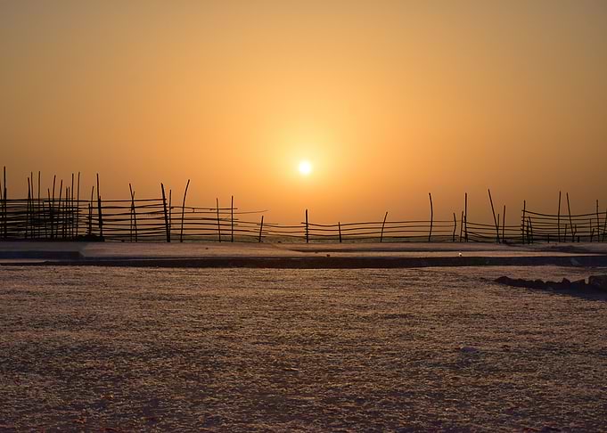 Sunset behind the fence