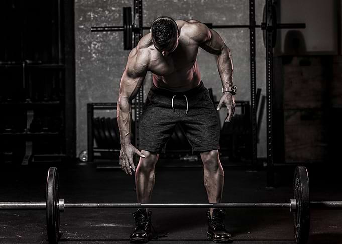 Muscular man about to lift a