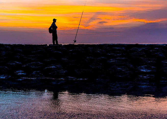 fisherman during sunset