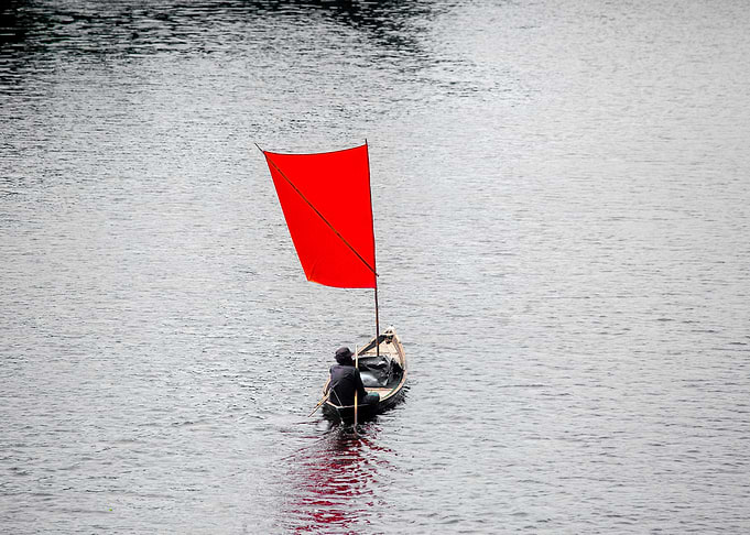 A Red color Sail Boat