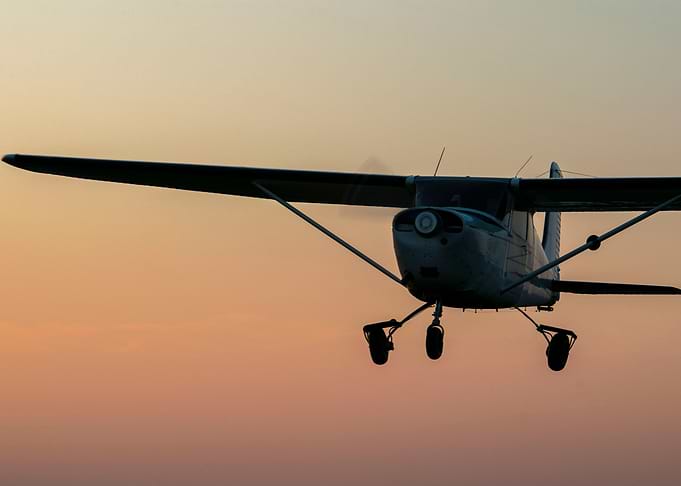 A plane in the golden sky.