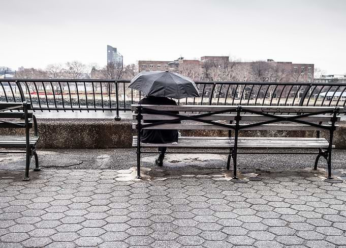man umbrella bench city