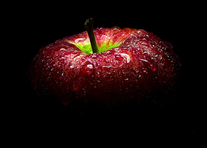 Fresh red apple in black