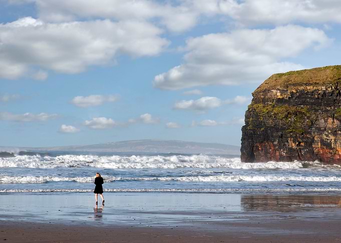 woman in heels on beach