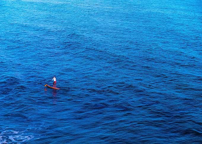 surfing with blue ocean