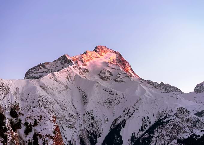 Sunset On A Snowy Mounain