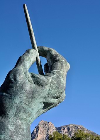 Conductors hand with baton