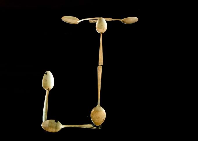 Letter J made of spoons