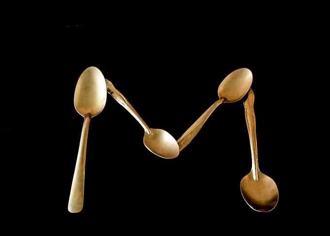 Letter M made of spoons