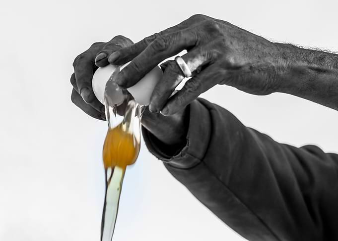 Hands man cracking an egg