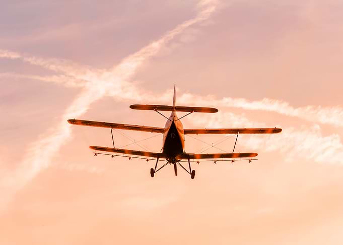 Plane flying in the sunset