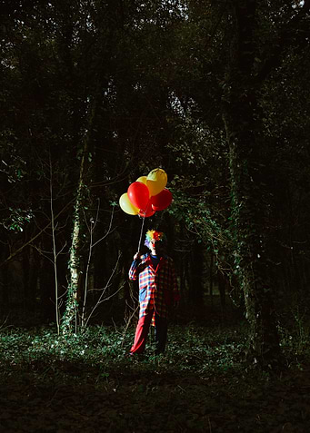 Creepy clown man standing