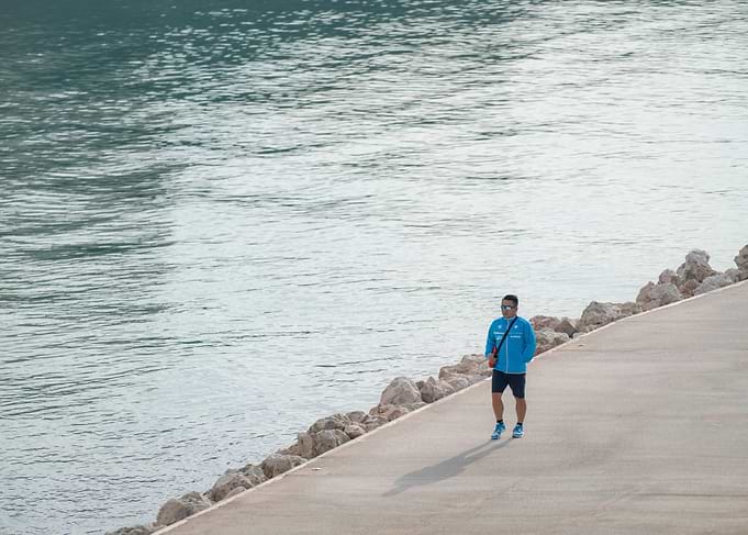 Man Walking Near Water