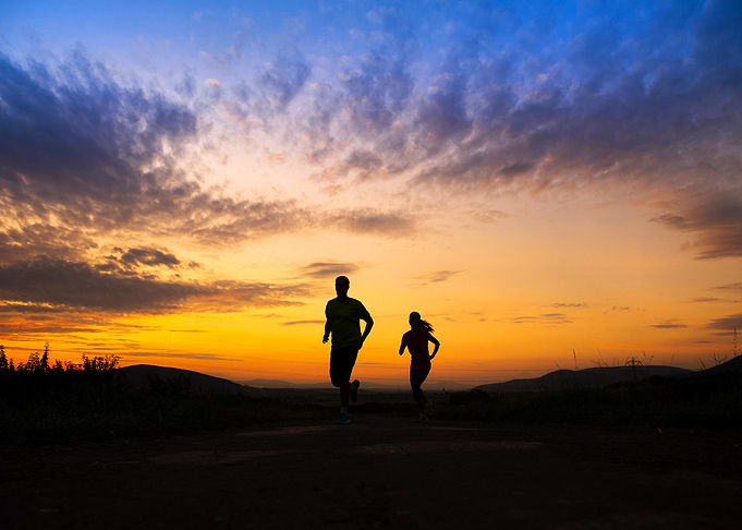 Silhouette Of Couple Runni