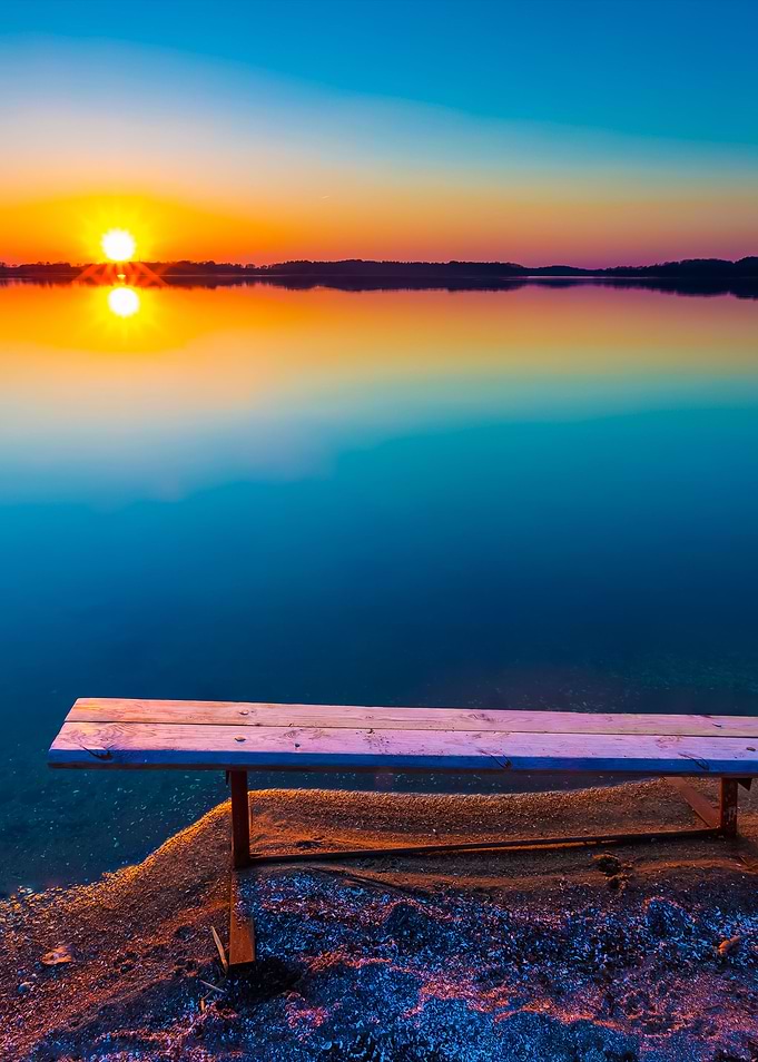 Bench On Lake Shore At Sun
