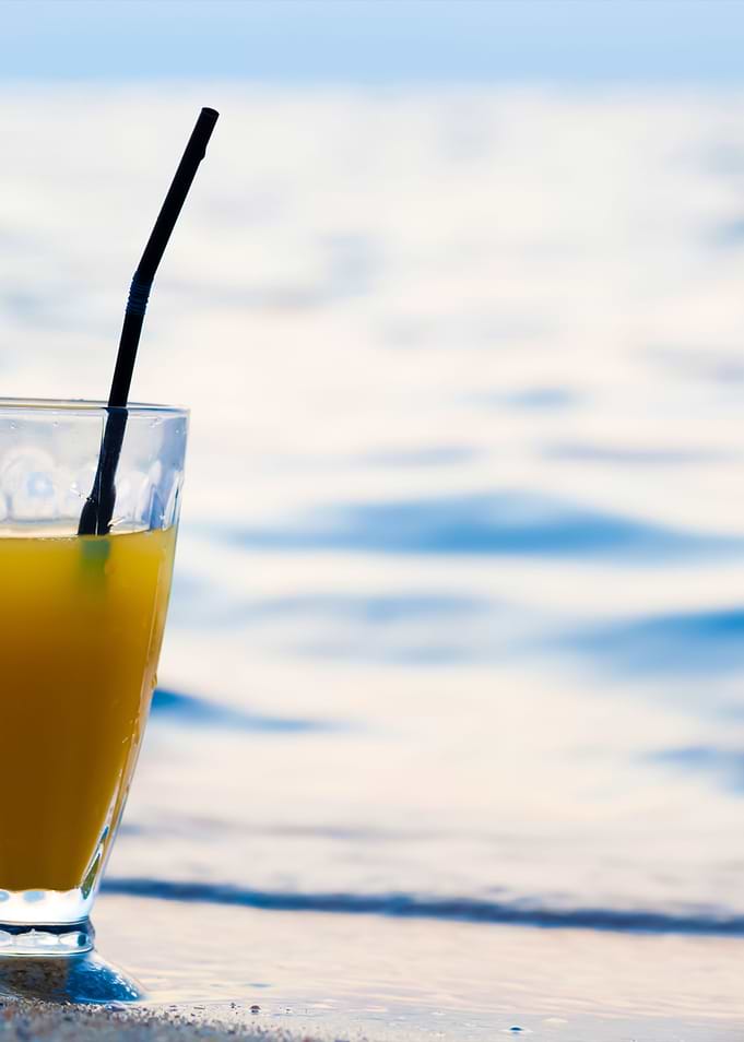 Glass Of Cocktail On Beach