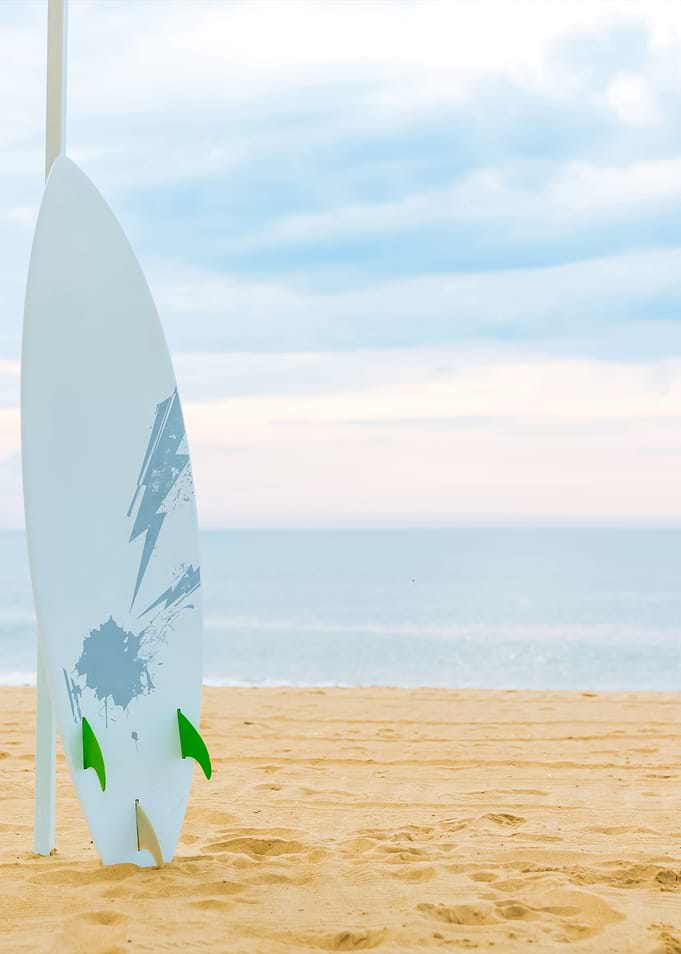 Surf Board In The Sand At