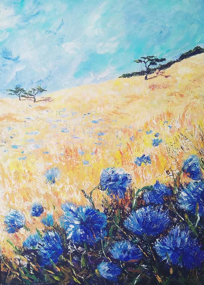 Summer field with cornflow