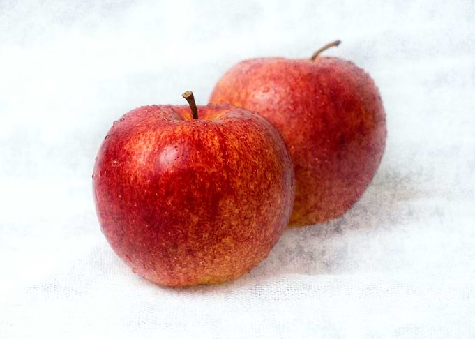 Two Red Apples On White