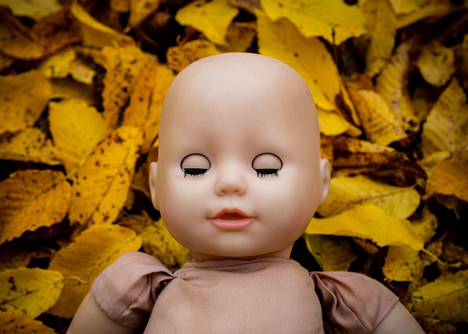 scary dark doll in yellow