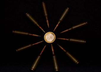 Coins and ammo on black