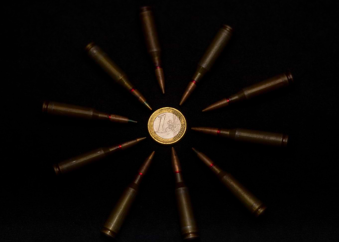 Coins and ammo on black