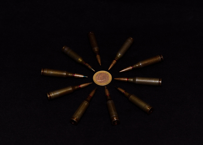 Coins and ammo on black
