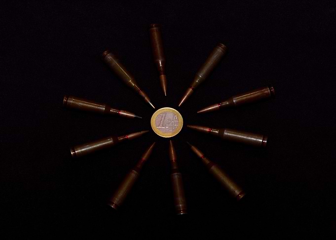 Coins and ammo on black