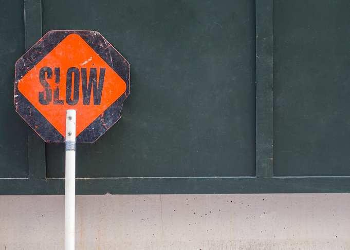 slow hand held sign