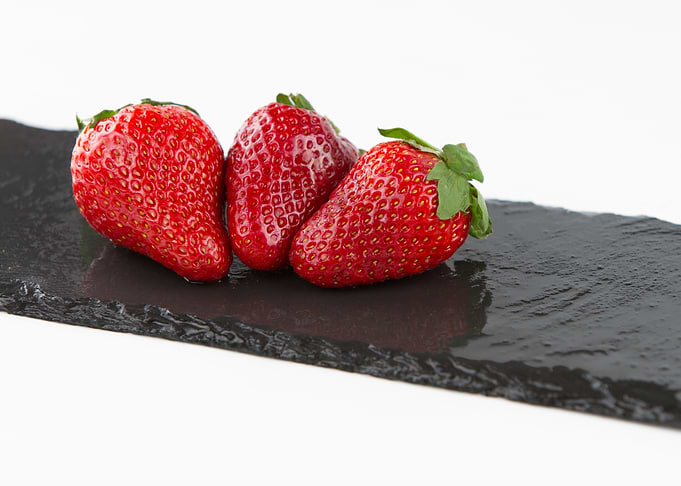 Three strawberries on slat