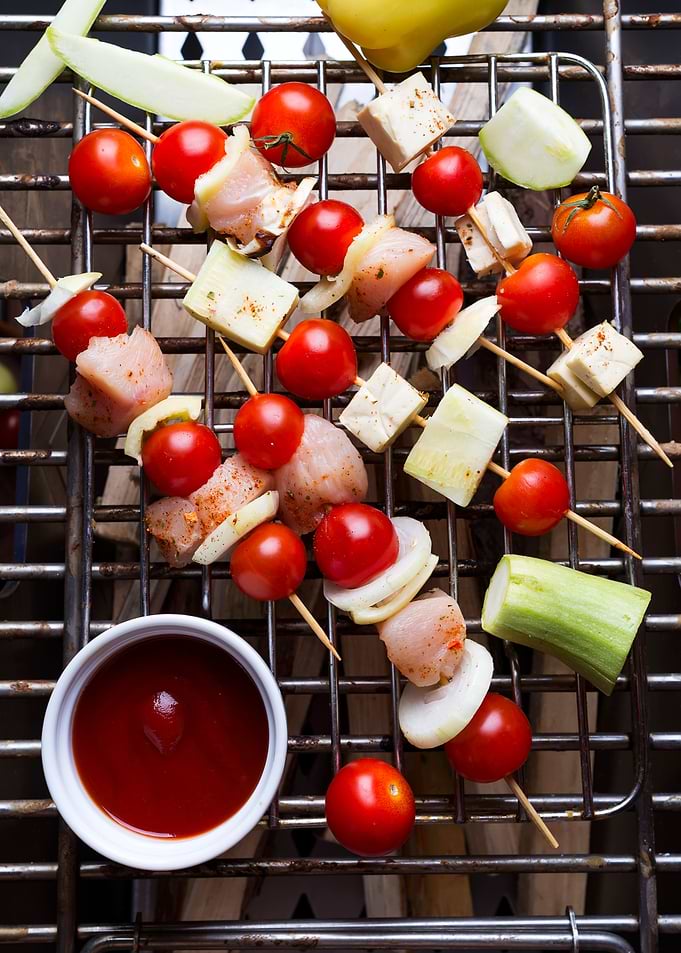 Raw skewers on a grill