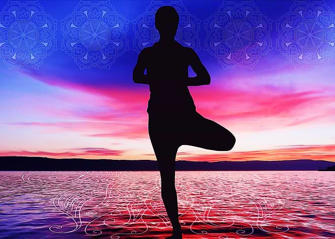 Man yoga at sunset